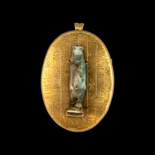 A Late 19th c. Egyptian Revival gold pendant with a Late Period faience amulet of Taweret.